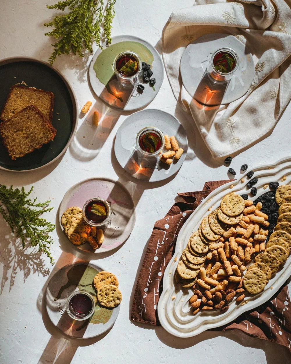 Table setting showcasing OWO Ceramic's perzonalized pottery serving platters for Jthoor