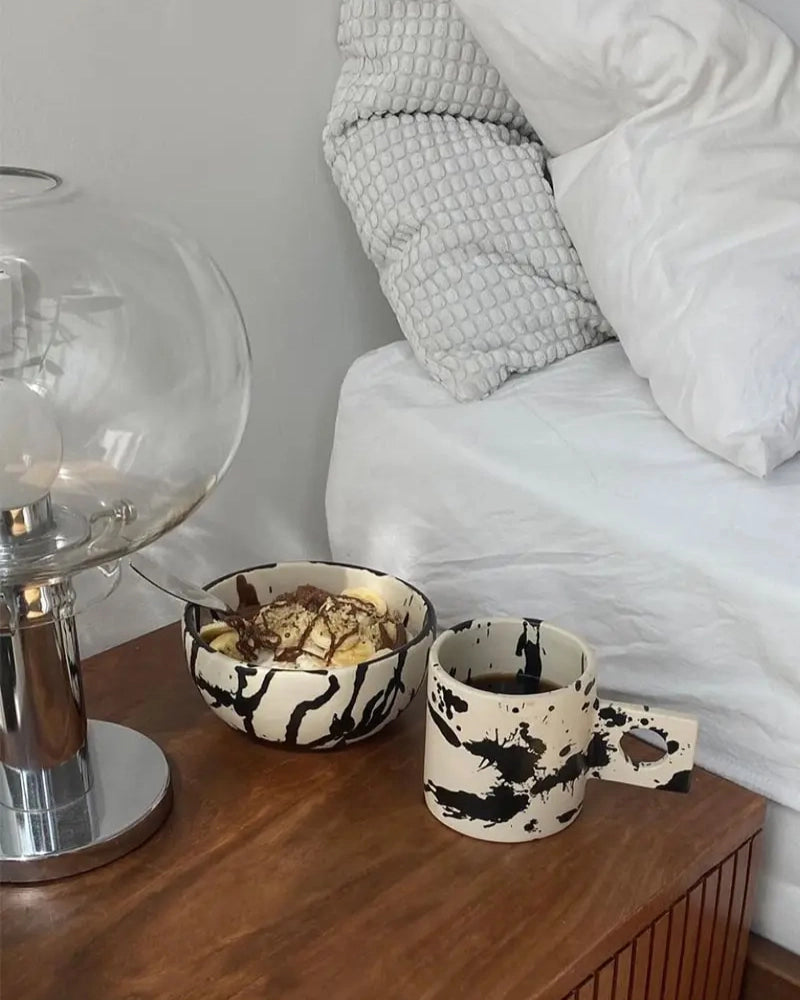 Handmade ceramic coffee mug and cereal bowl with hand-painted black splatters by OWO Ceramics