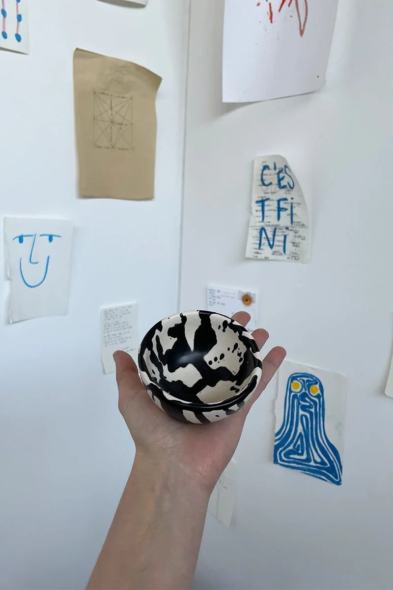 Handmade ceramic dipping bowl with hand-painted black splatters