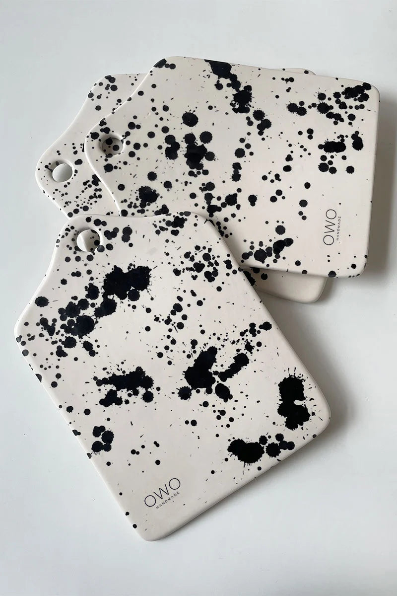 Handcrafted pottery cheese platter boards with hand-painted black splatters