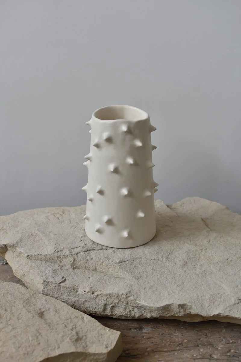 Handmade white ceramic vase with spikes