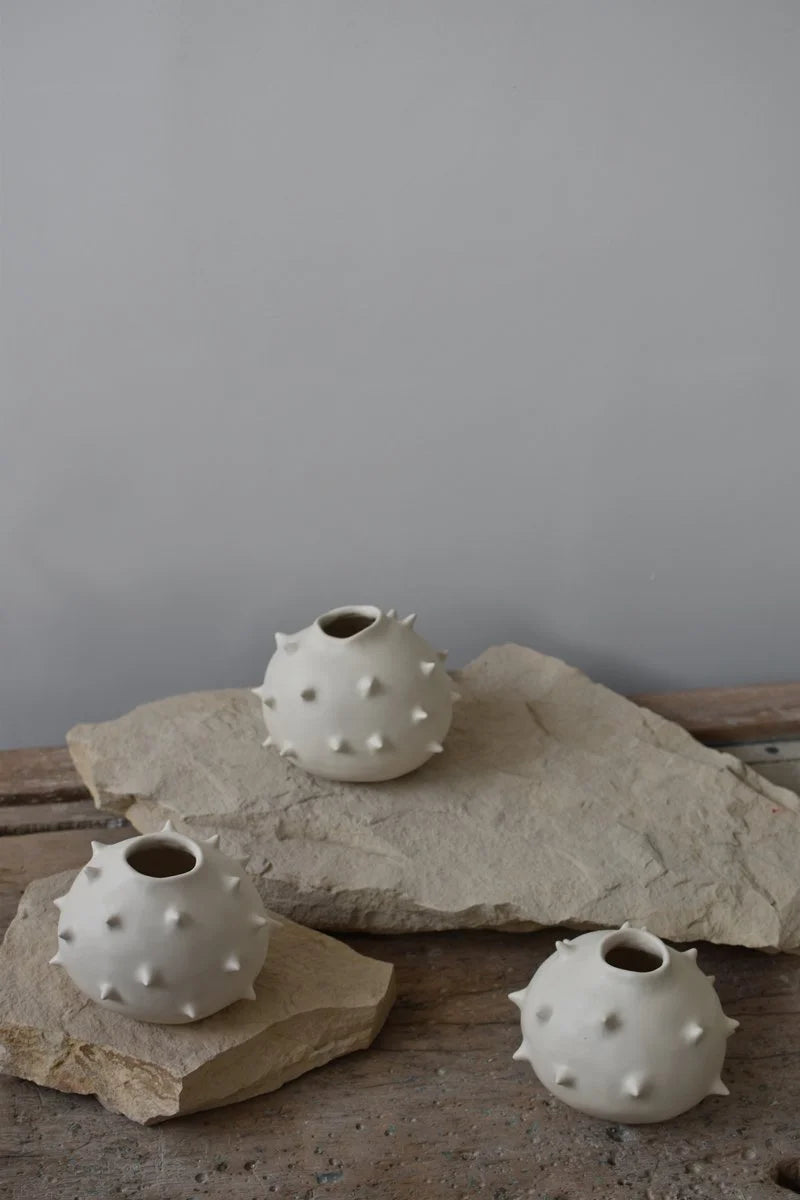 Handmade white round ceramic vases with spikes by OWO Ceramics