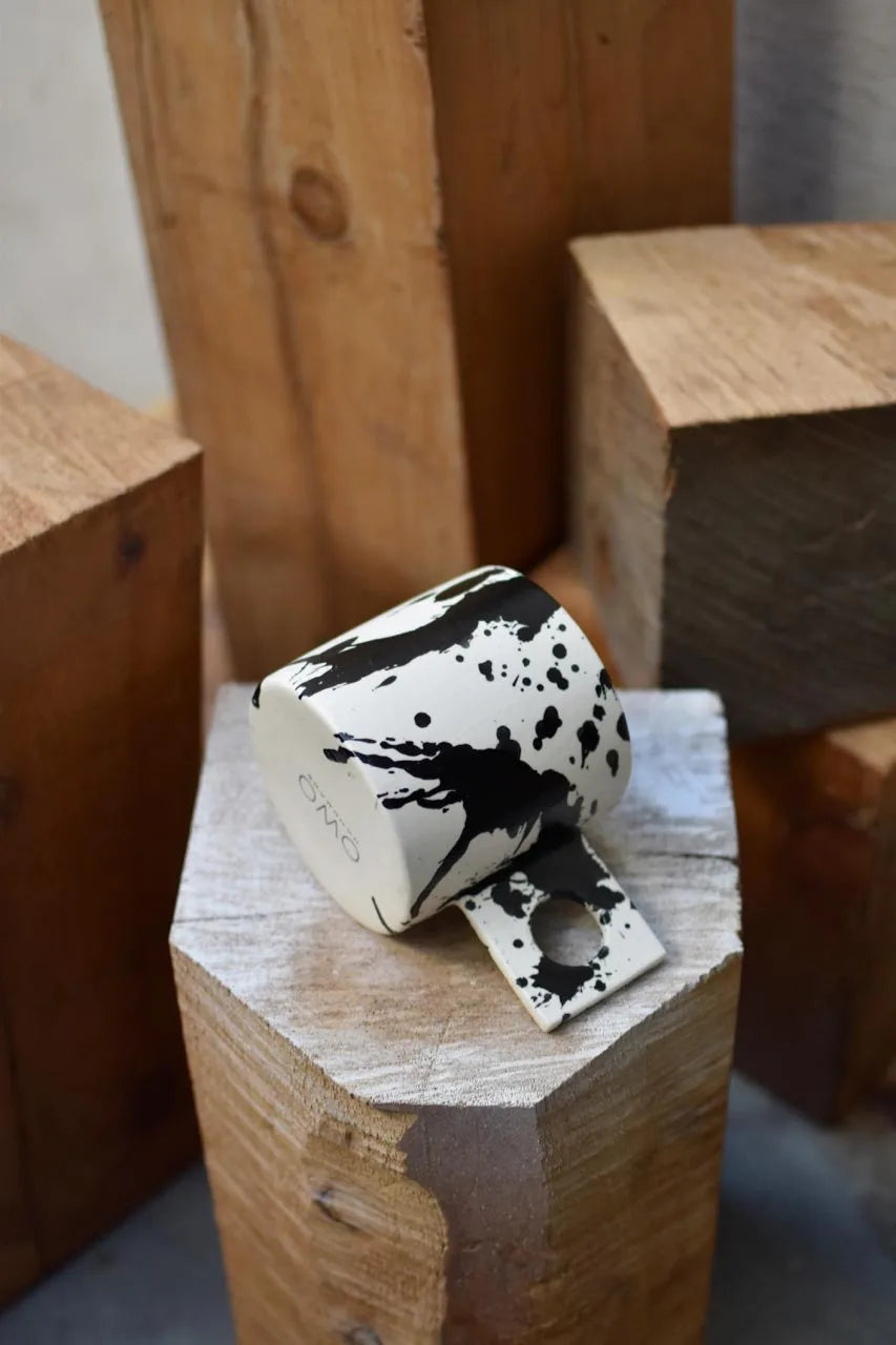 Handmade coffee mug with black splatters by OWO Ceramics