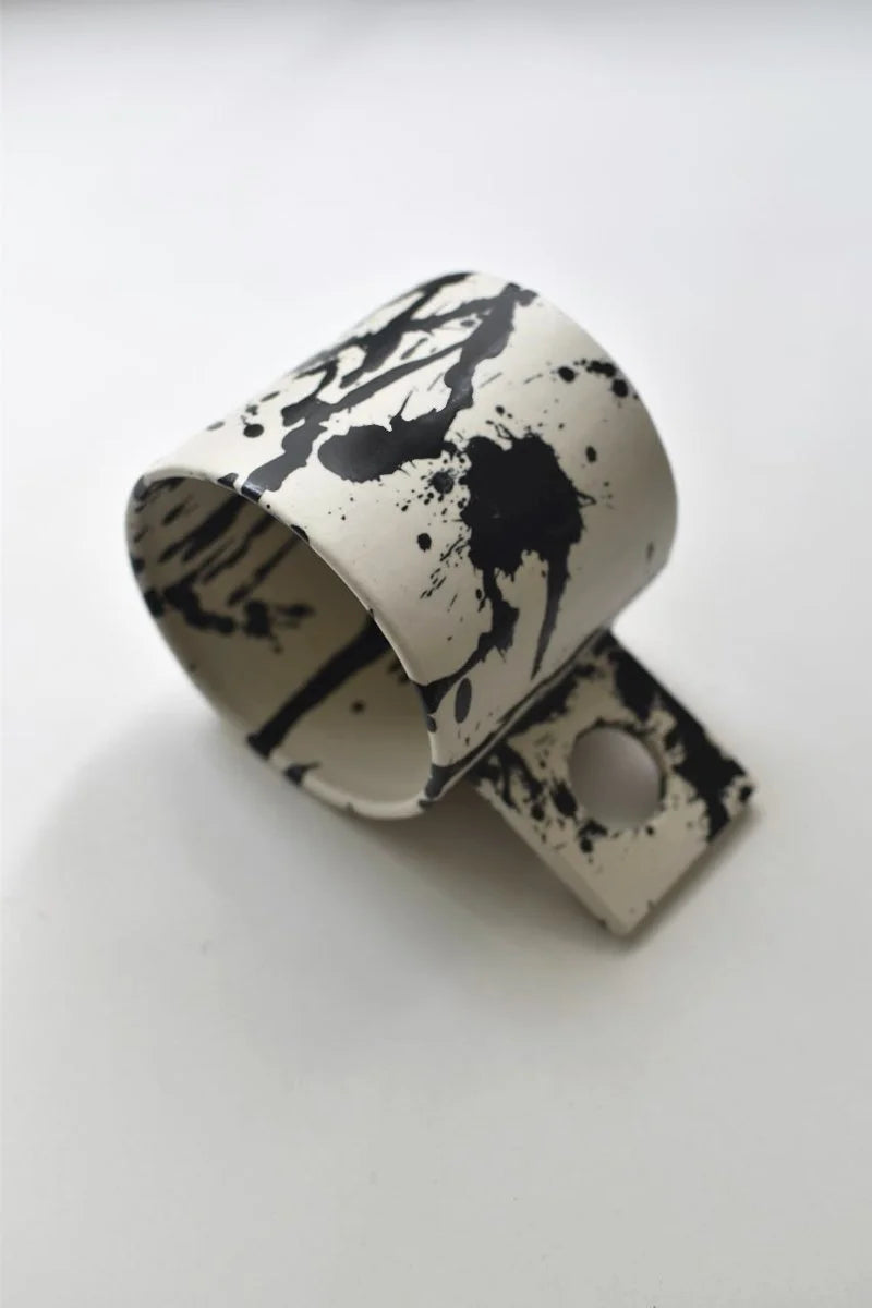 Handmade coffee mug with black splatters by OWO Ceramics