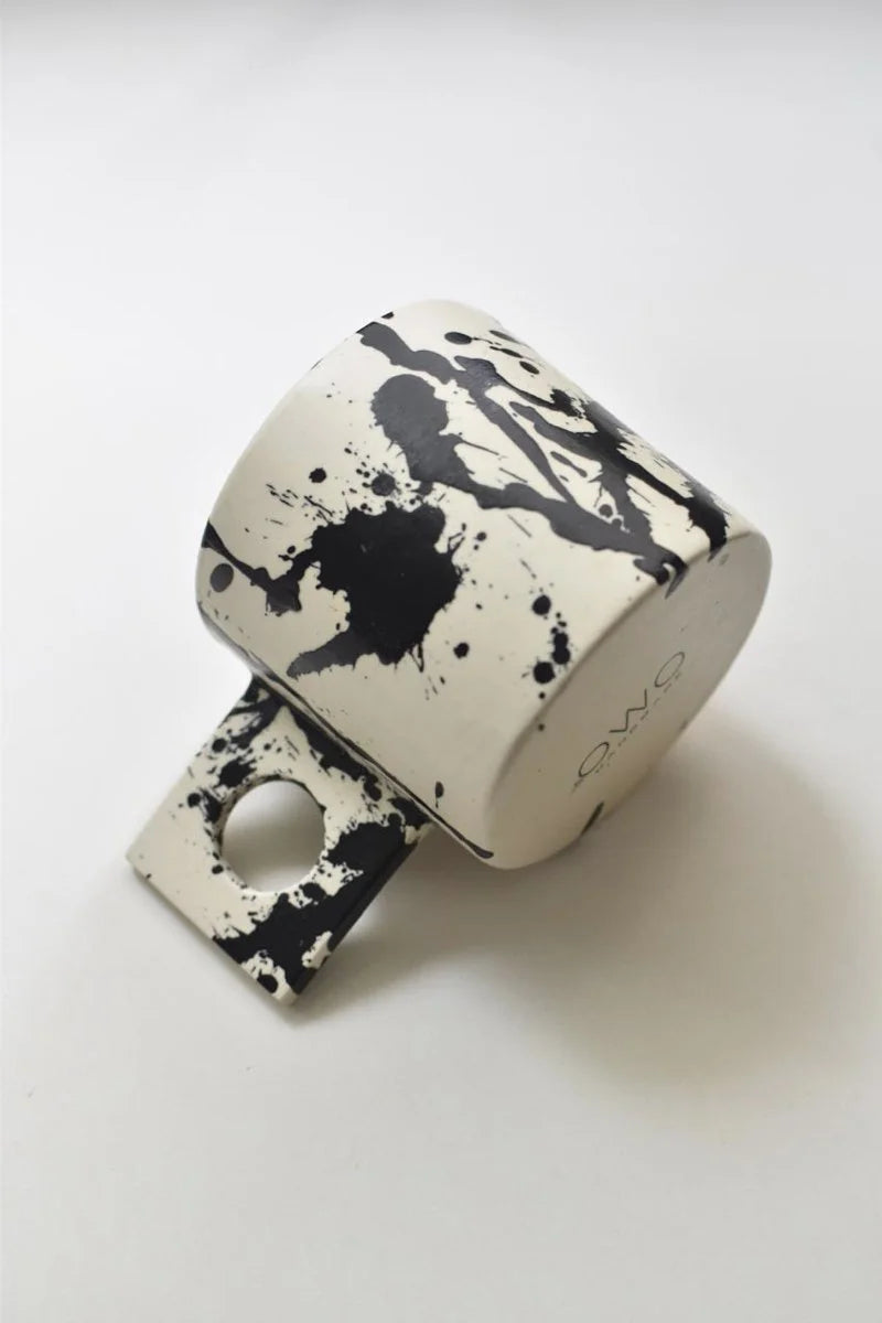 Handmade coffee mug with black splatters by OWO Ceramics