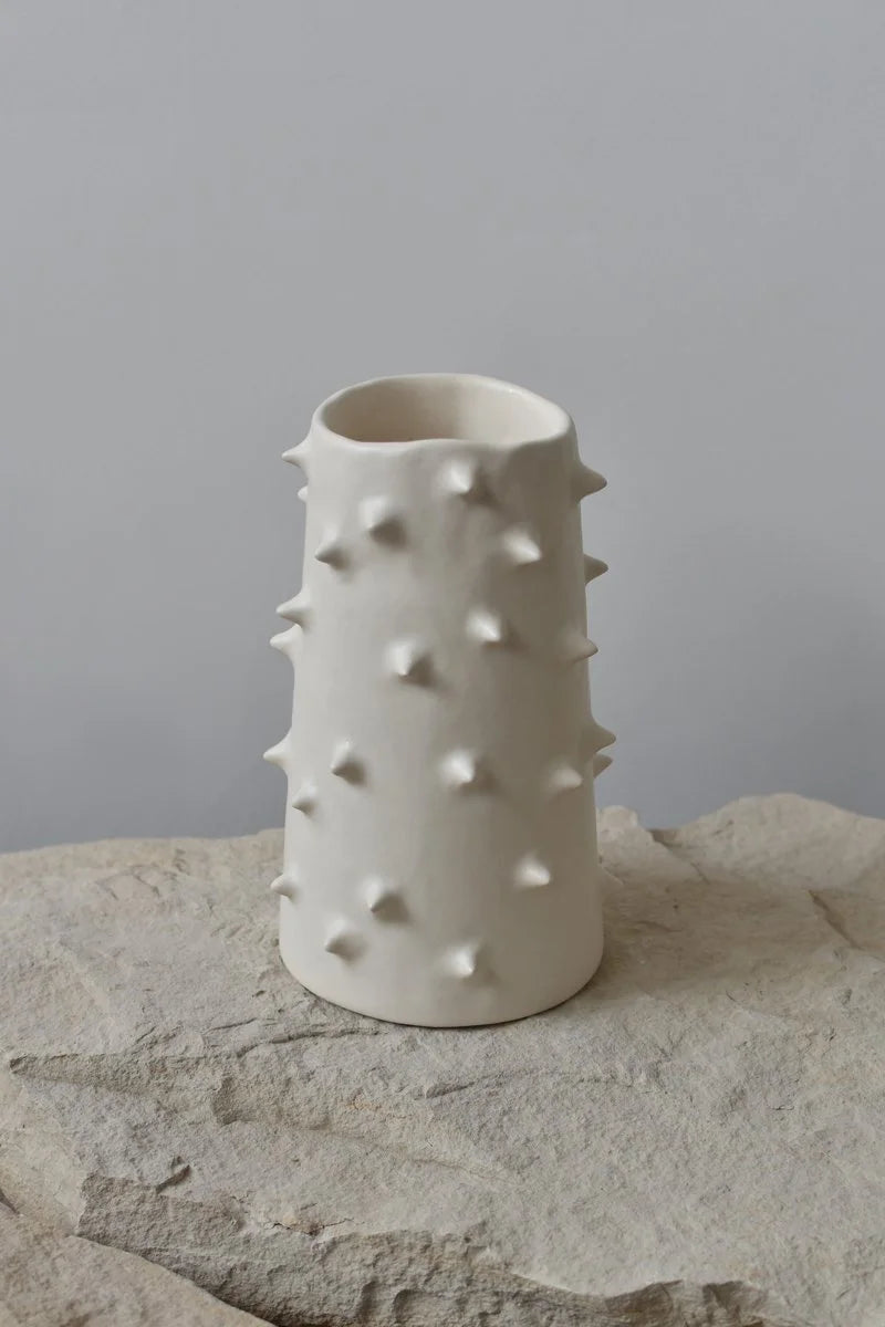 Handmade white ceramic vase with spikes