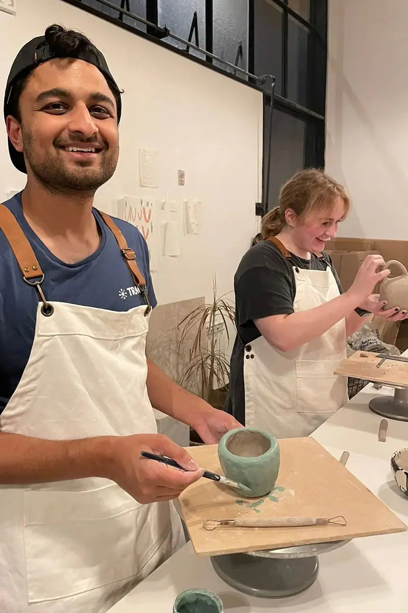 Couple crafting their own ceramic mugs at OWO’s art class in Buenos Aires